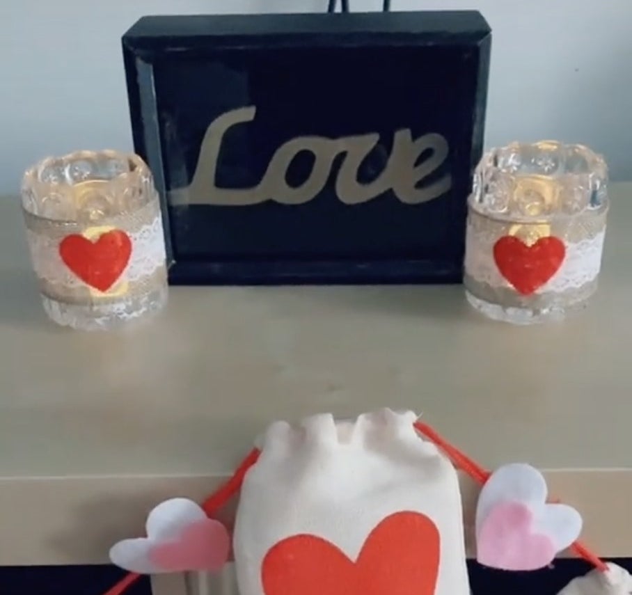 Two glass candle holders with lace ribbon wrapped around and an added heart