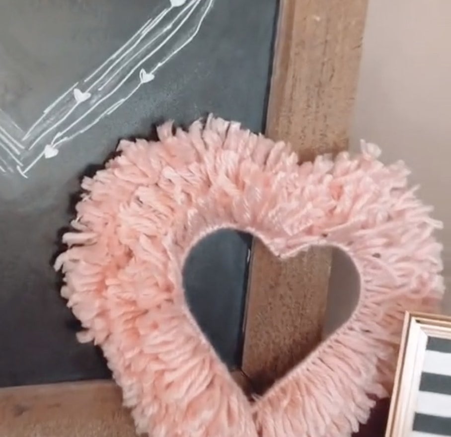 A heart made out of pink yarn