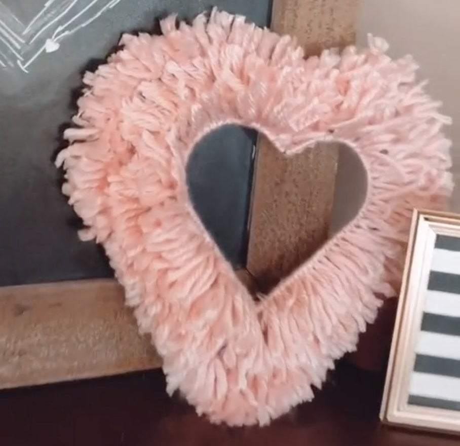 A heart made out of pink yarn