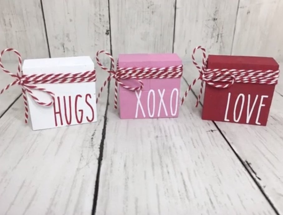 White, pink, and red blocks with hugs and love written on them
