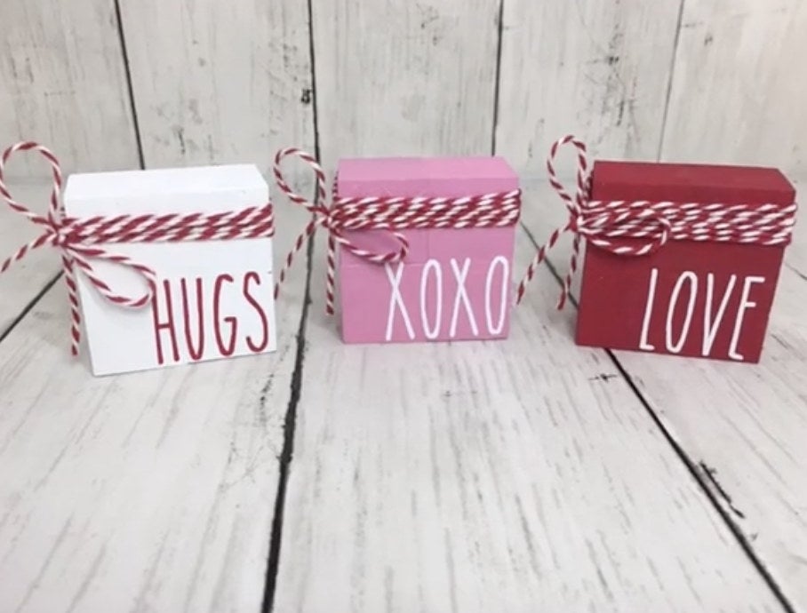 White, pink, and red blocks with hugs and love written on them