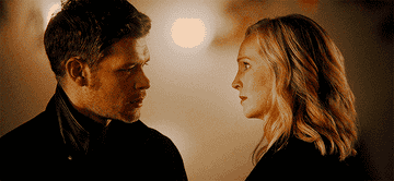 Klaus leaning in to kiss Caroline