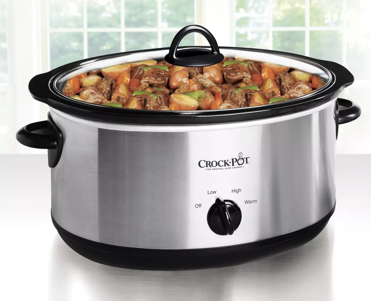 A slow cooker with food inside
