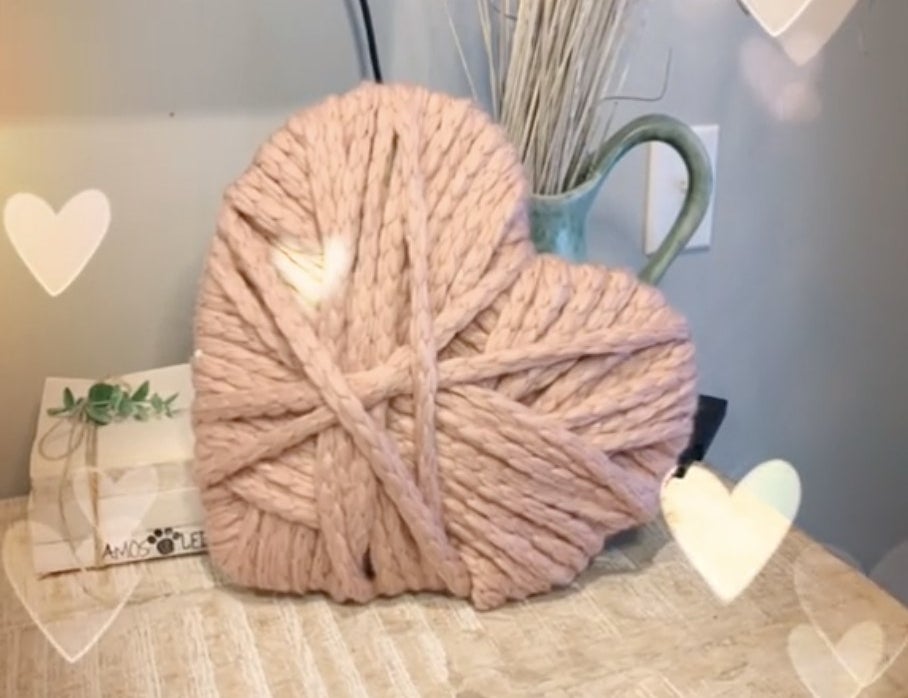 A heart made of layered, thick pink yarn