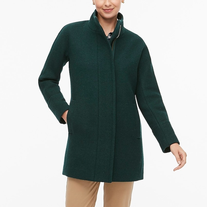 a model wearing the wool coat in green