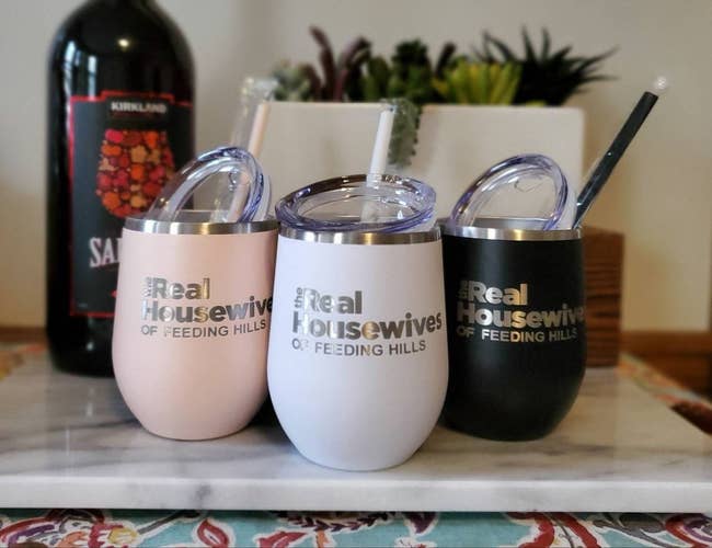 a light pink, white, and black set of stemless wine tumblers with 