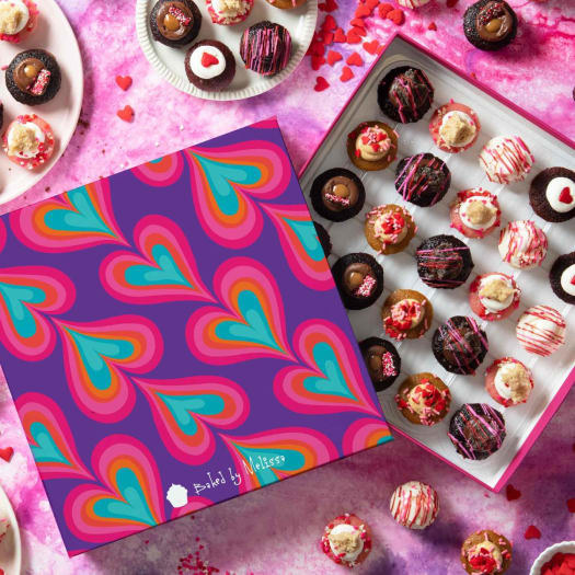 A tie dye heart cupcake box full of 25 mini cupcakes 