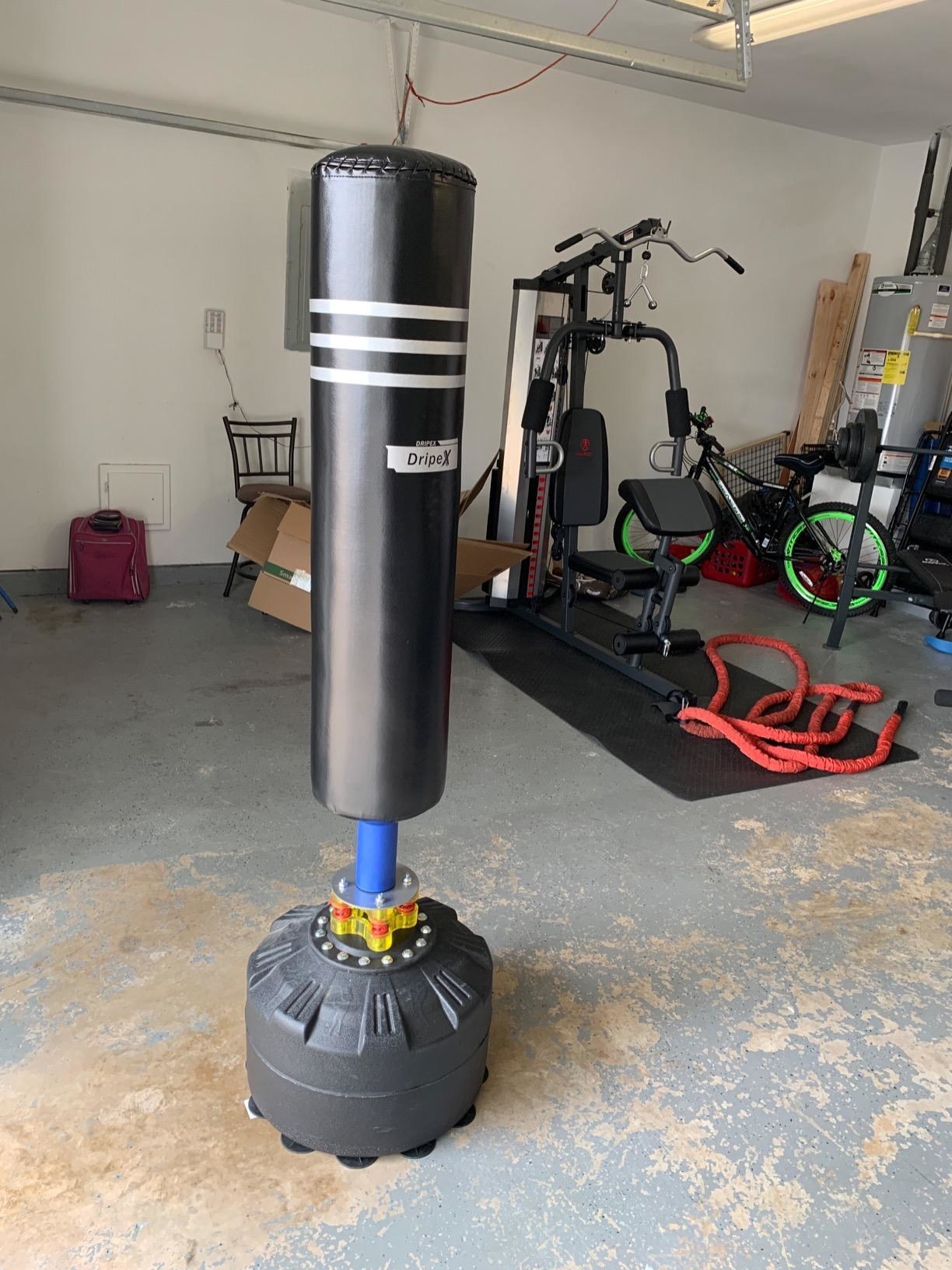 A reviewer&#x27;s photo of the punching bag in their home gym