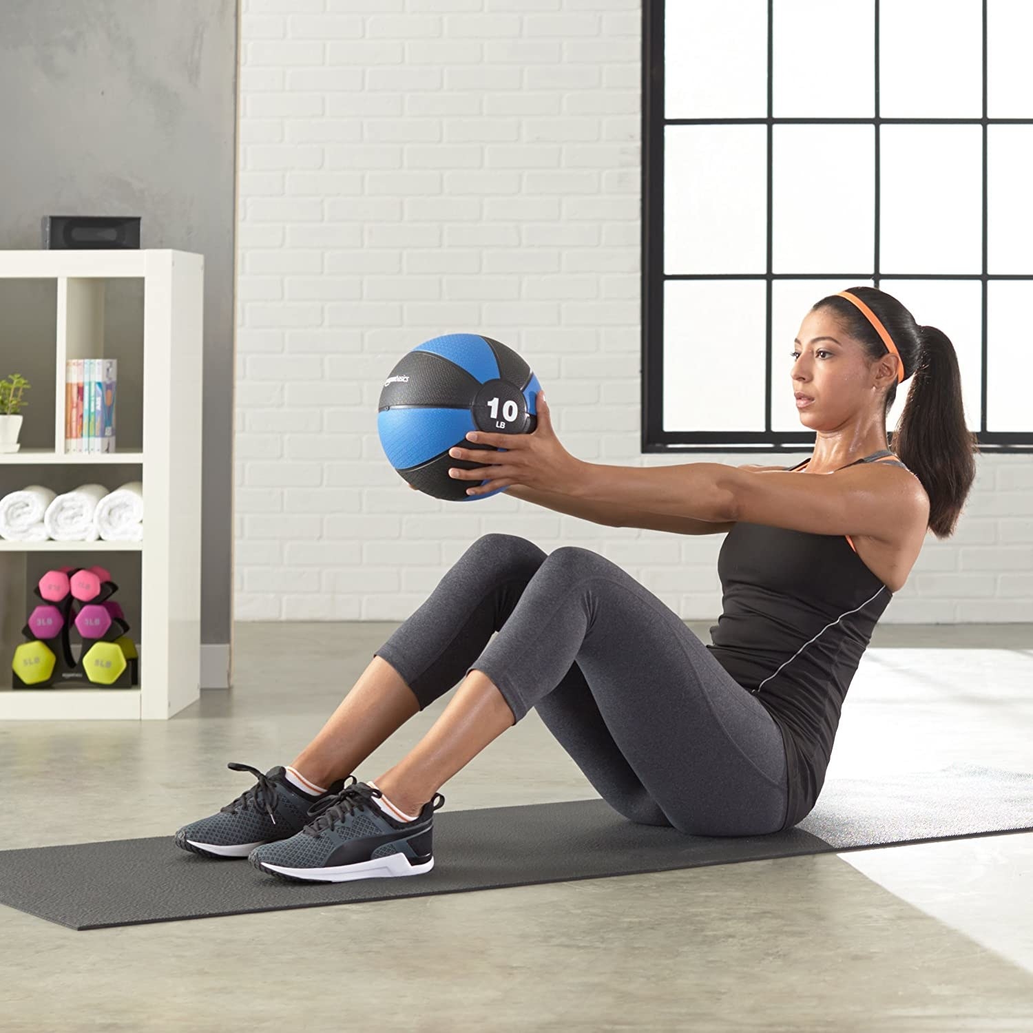 A model using the blue and black medicine ball