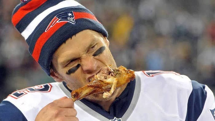 Tom Brady eating a turkey drumstick.