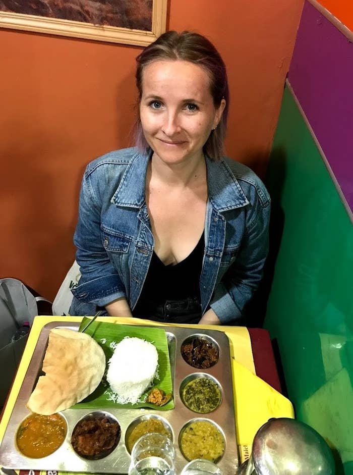 Woman with plate of Indian food