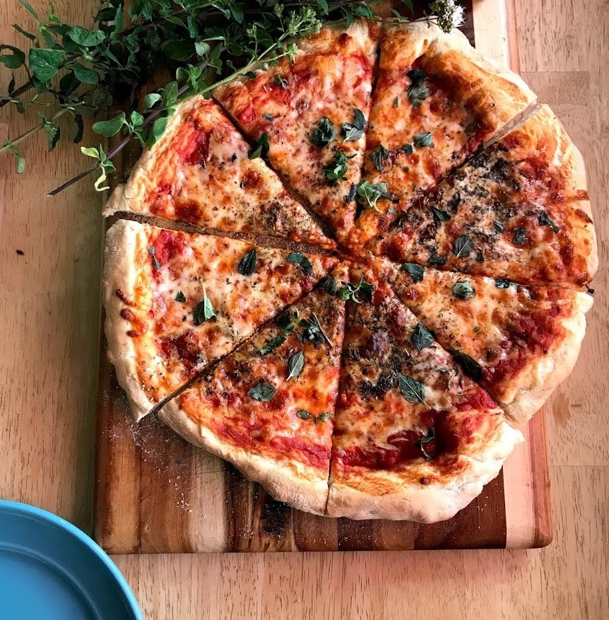 Pizza with herbs on top