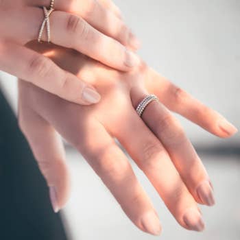 Model wearing three stackable rings on finger