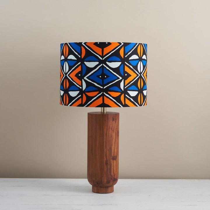 same lamp and lampshade in a different blue, orange, and white African patteern