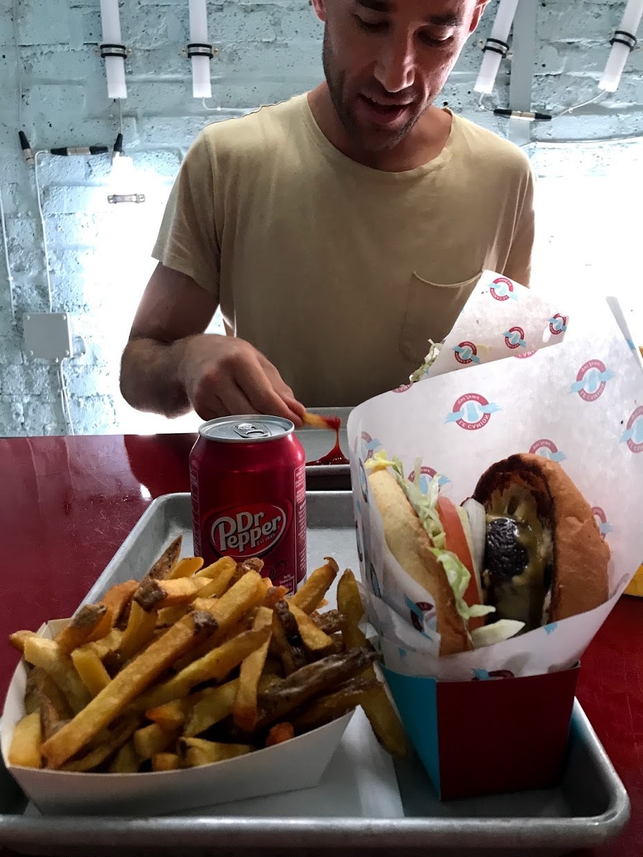 Plate of food with man in background