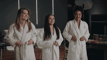 Sutton, Jane and Kate taking their robes off