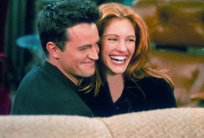 Matthew Perry and actress Julia Roberts hug each other on the set of "Friends."