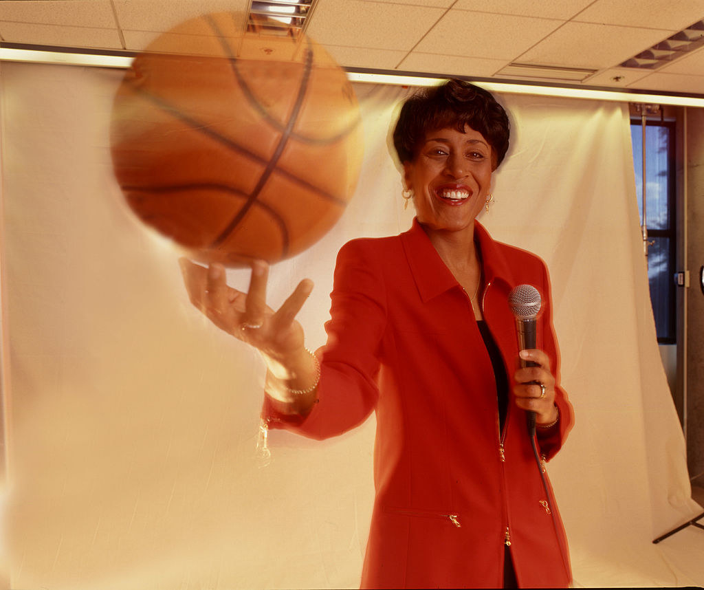 Robin Roberts holding a microphone and basketball