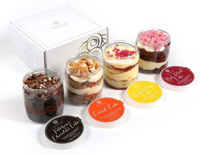 four different types of cakes in jars