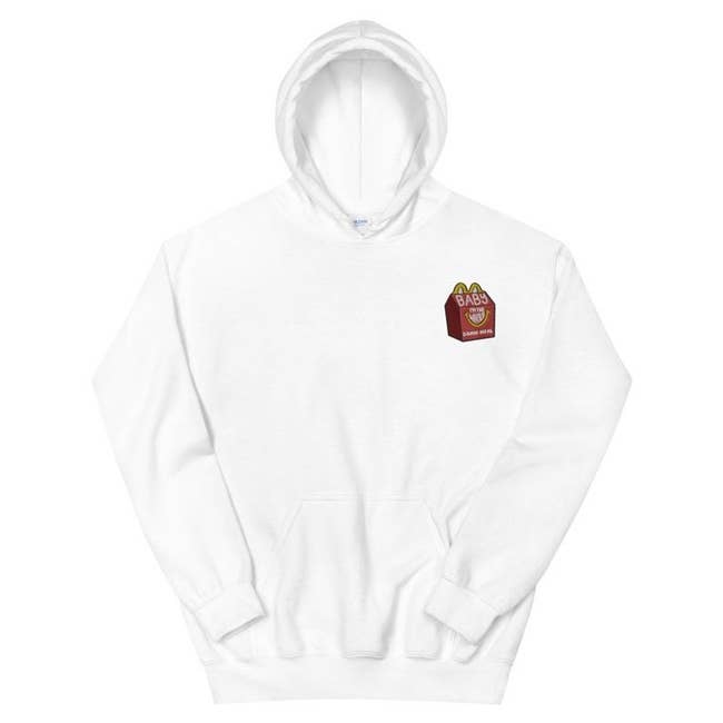 The white pullover hoodie with a front pocket and the small embroidered graphic on the chest
