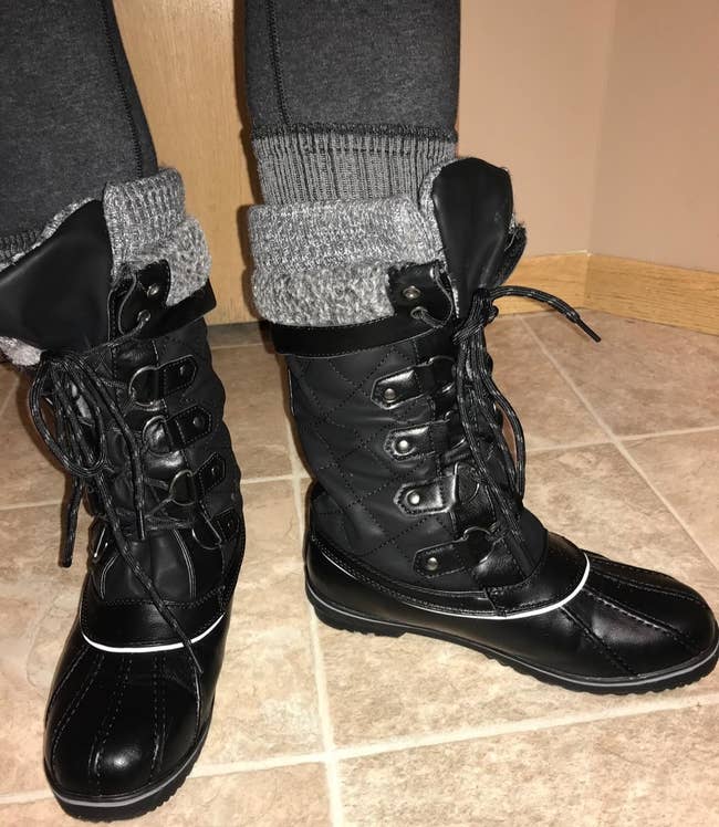 reviewer wearing the boots in black