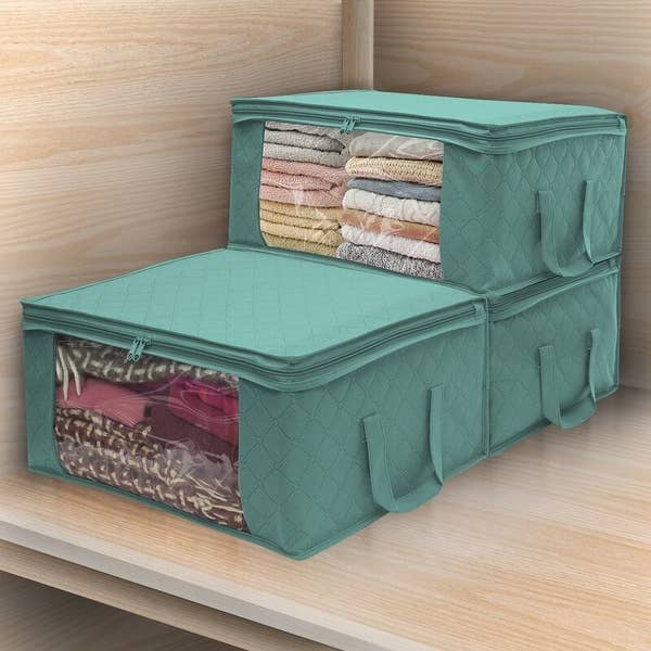 Aqua underbed storage bins with red, pink and yellow clothes inside