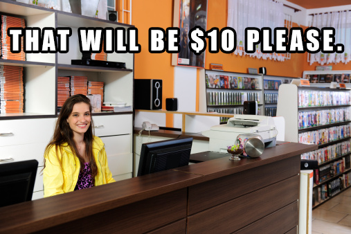 A woman sitting behind the desk at a video rental store asking you to pay a $10 late-return fee