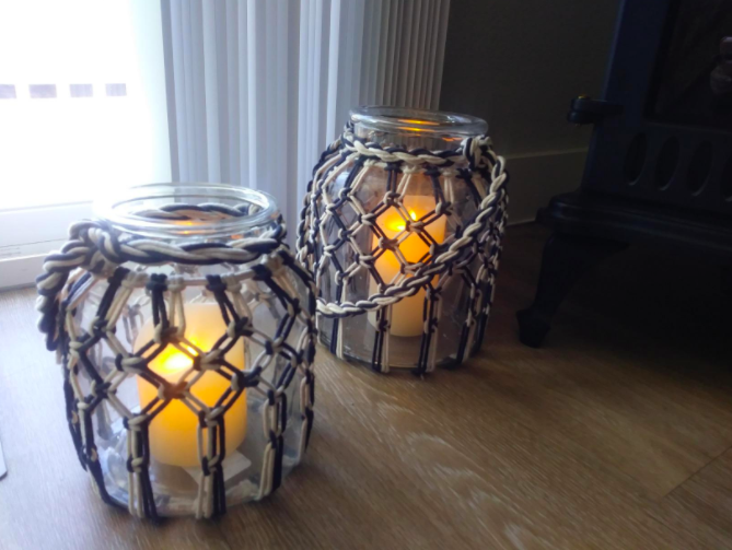 a reviewer's photo of the flameless candles inside a canister