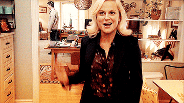 Leslie Knope from Parks and Rec doing and excited dance