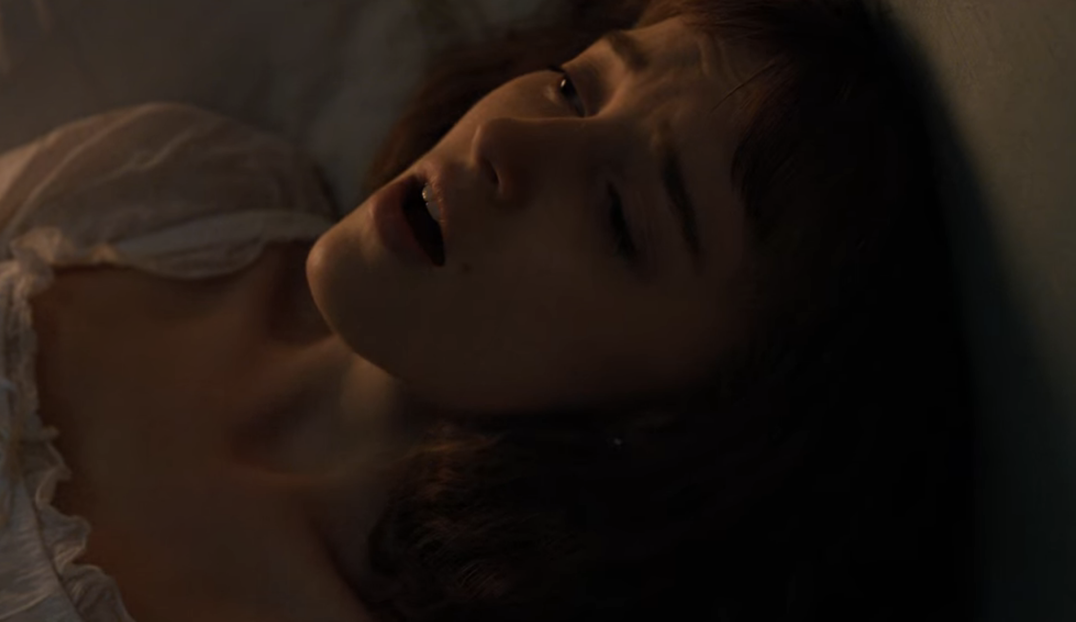 Daphne in bed during the masturbation scene