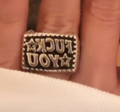 A mirror image of the ring that says &quot;Fuck You&quot;