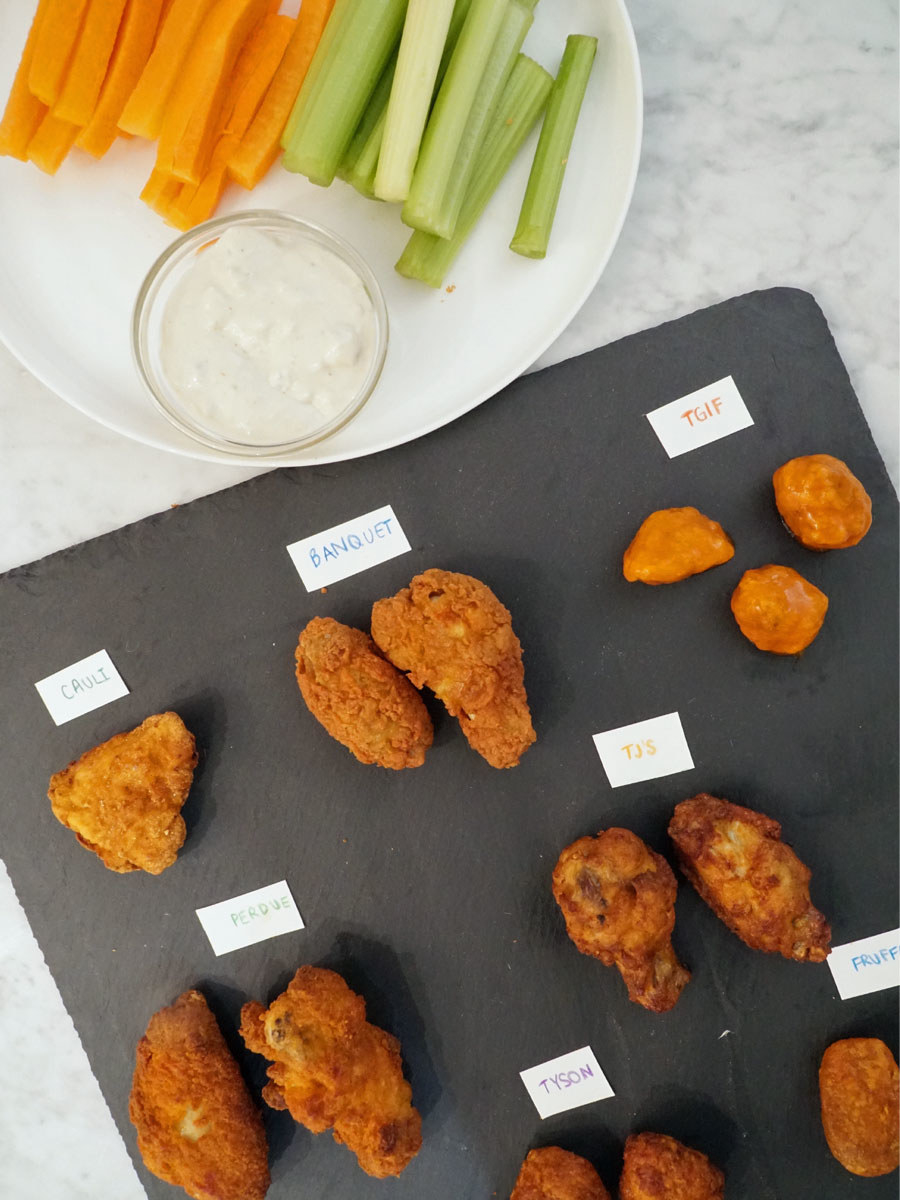Crispy wings on a platter with a side of carrots, celery, and blue cheese.