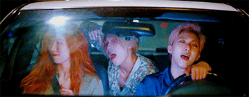 three singers in a car, dancing