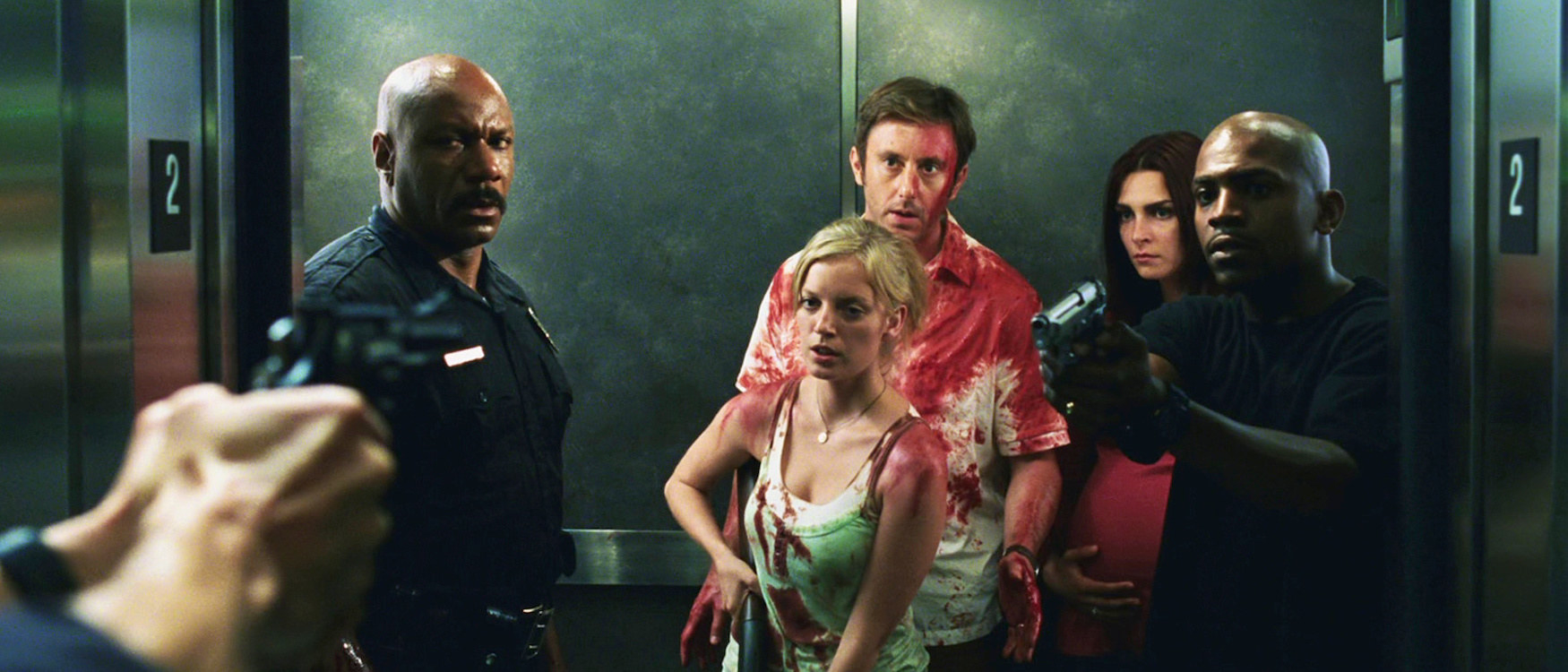 A group of bloodied survivors in an elevator, trying their best to escape the zombie apocalypse 