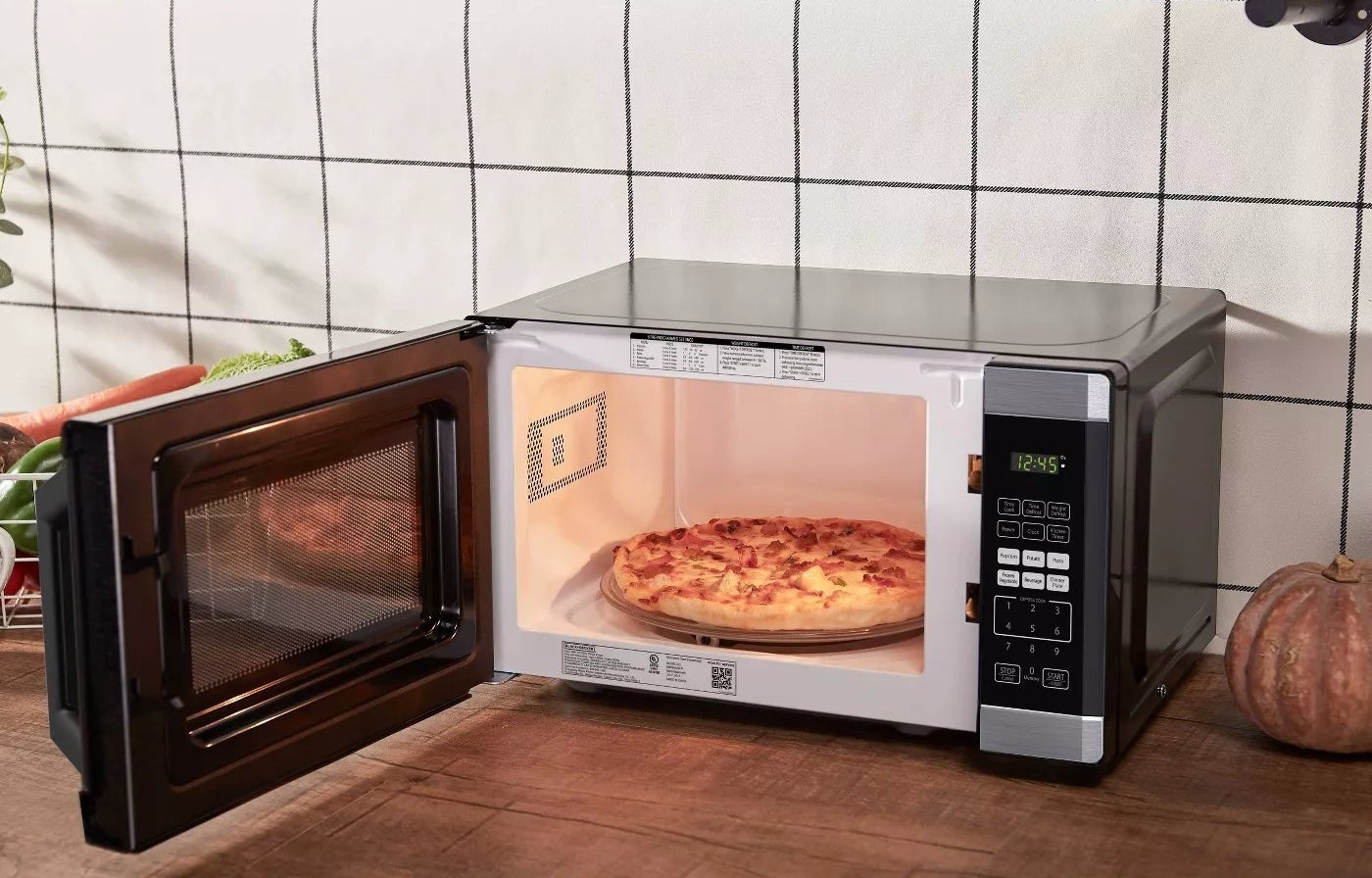 A pizza on the microwave&#x27;s turntable