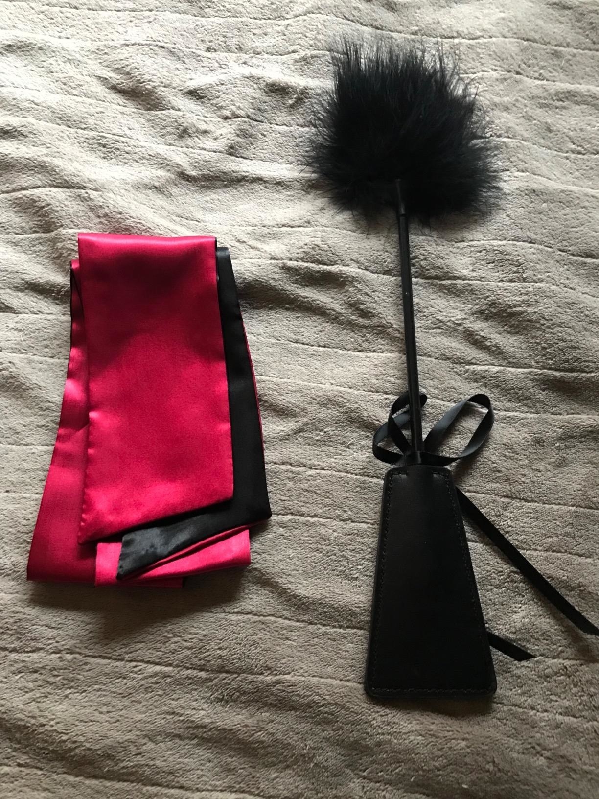 reviewer image of the Sport Whip and Feather Tickler on a bed