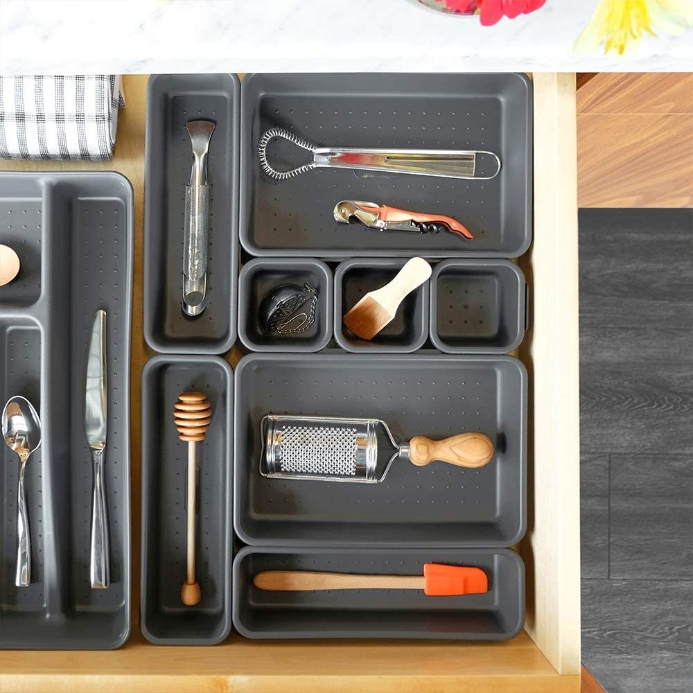 An open drawer filled with the interlocking storage containers