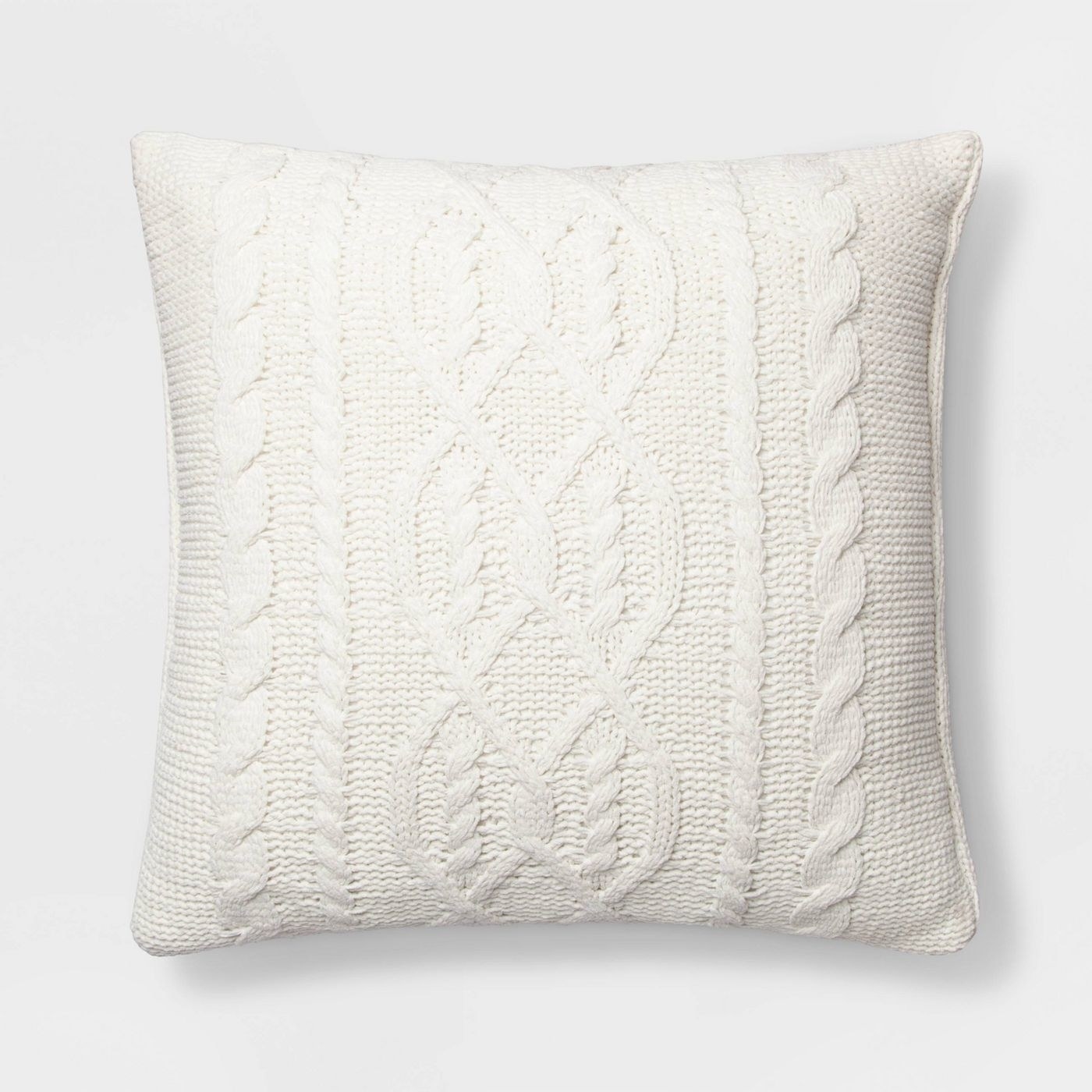 A white throw pillow with a cable knit pattern on it