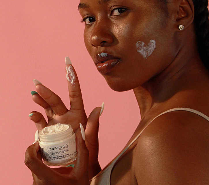 model holding a jar of Demoseà skin-softening cream 