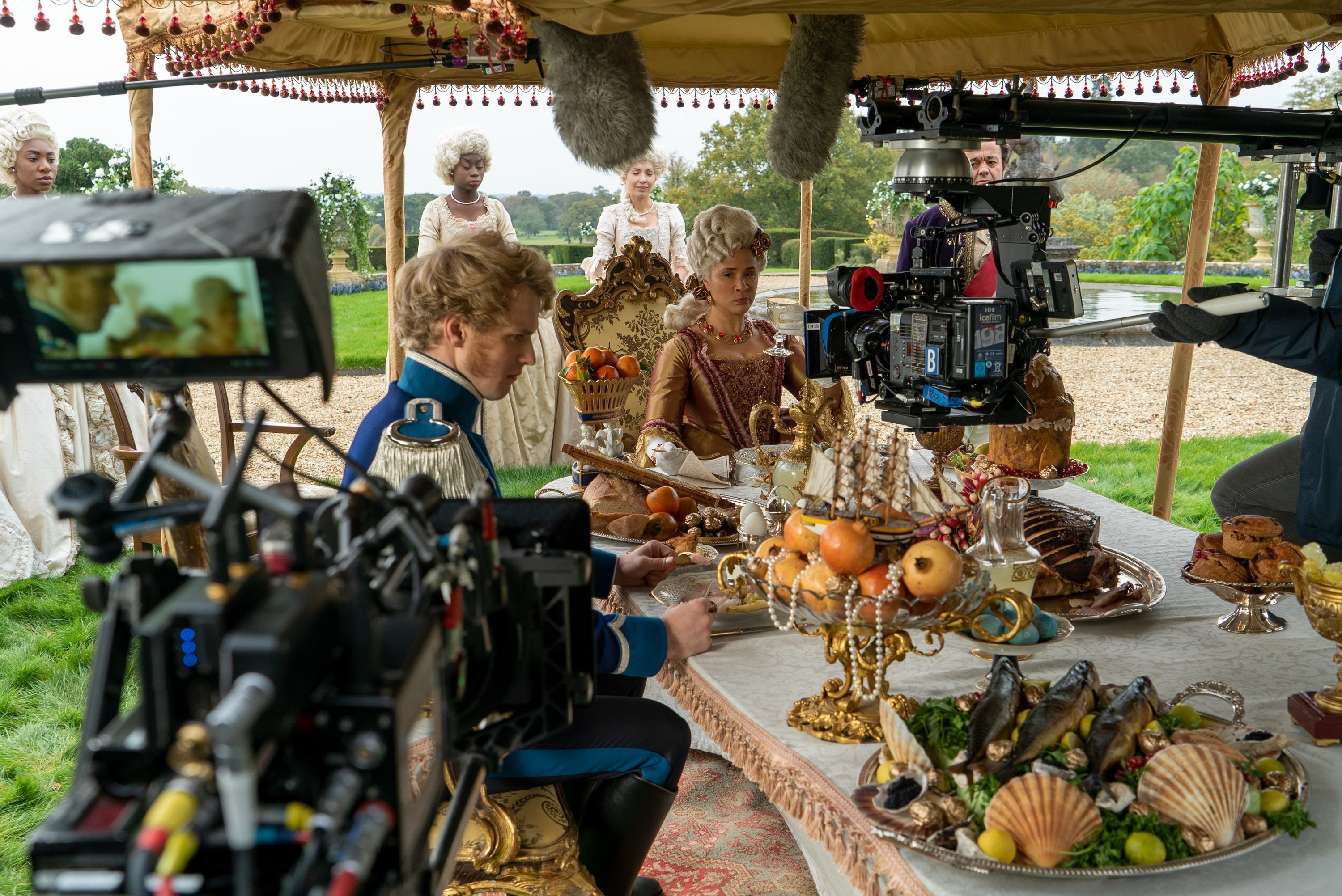 Golda Rosheuvel Freddie Stroma filming a dinner scene outside 