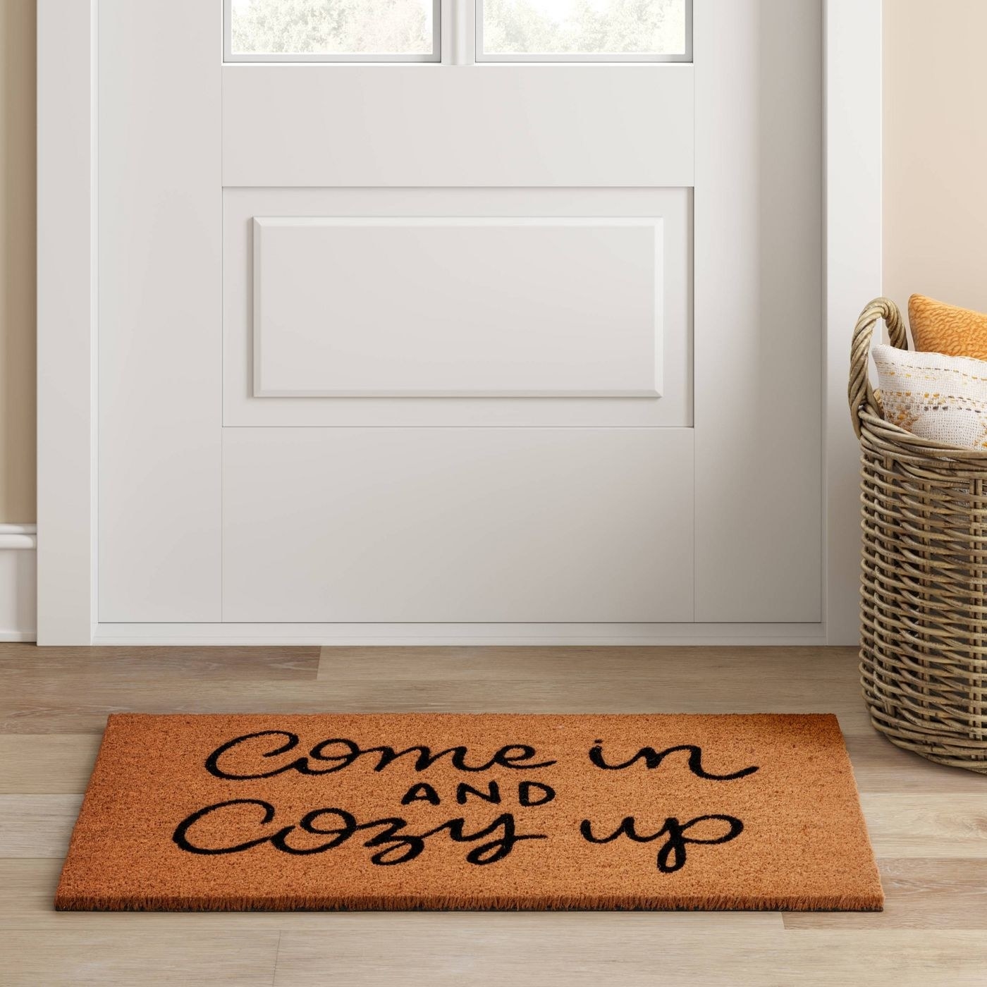 A home with a doormat that says &quot;come in and cozy up&quot;