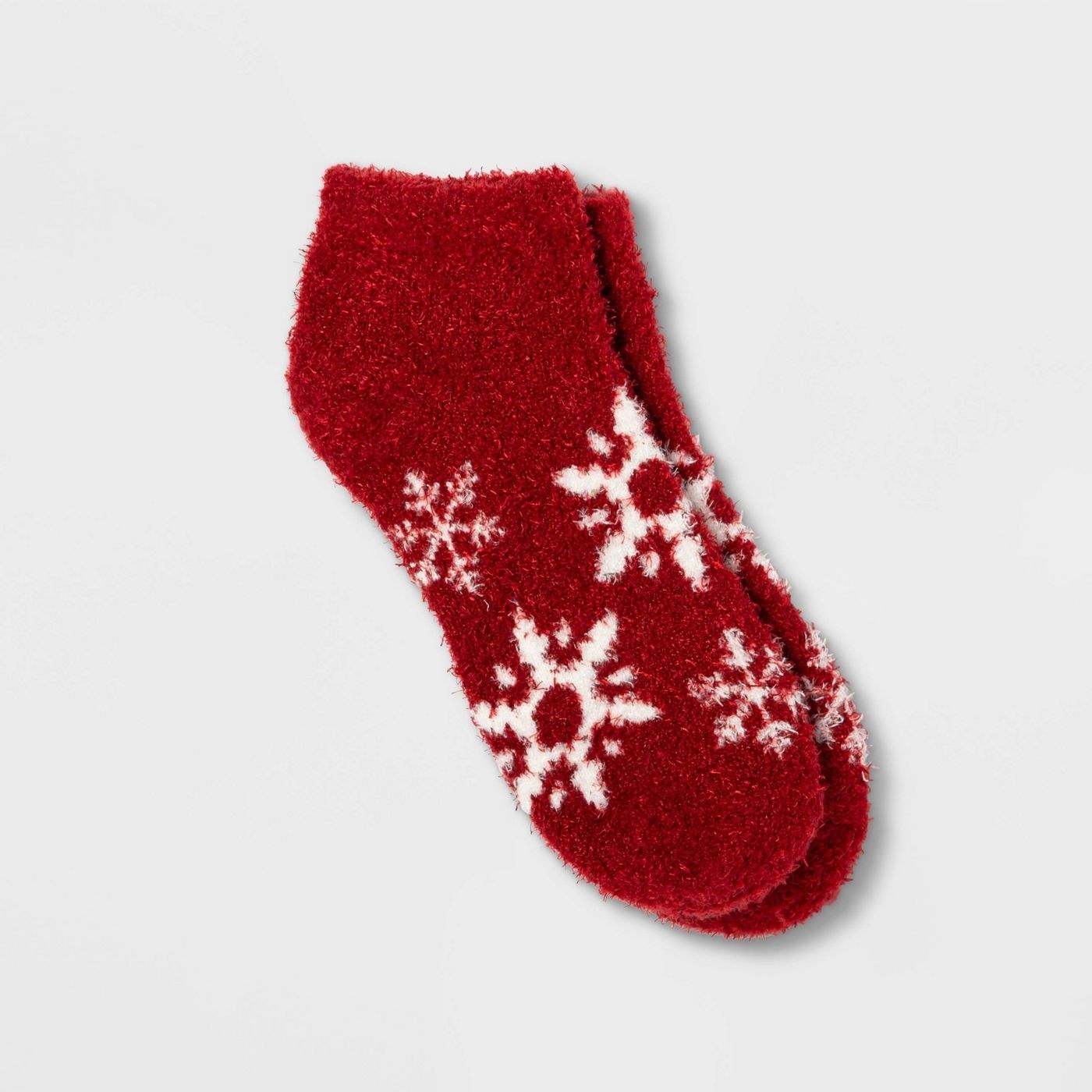 A pair of red ankle socks with snowflakes on them. 