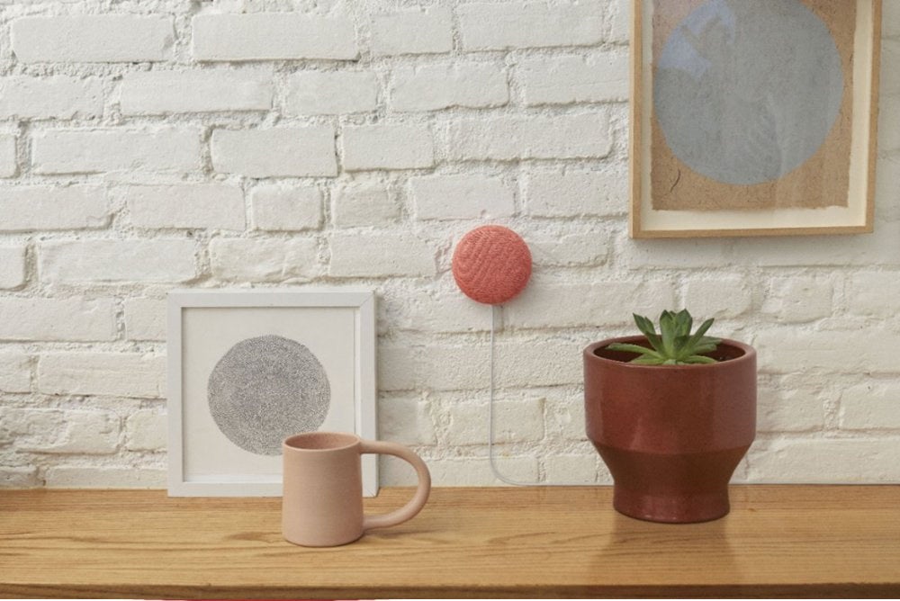 The pink speaker hanging on a wall