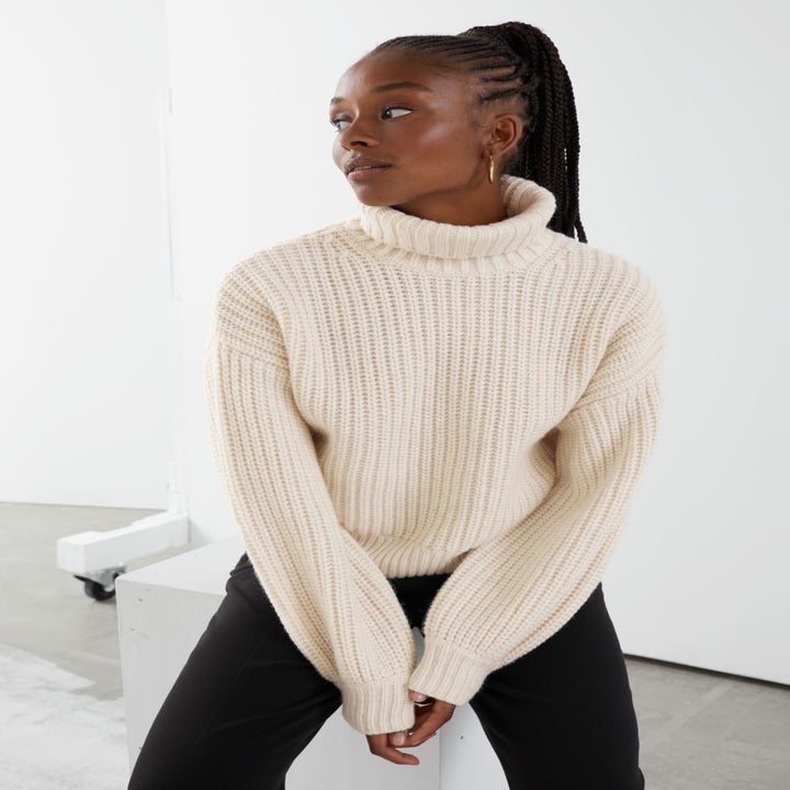 model wearing white turtleneck sweater