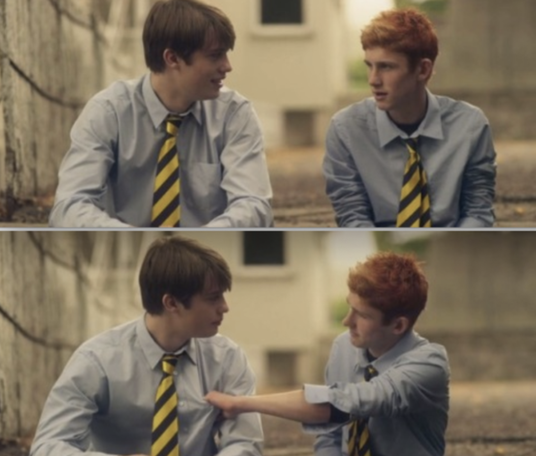 Ned and Conor sitting together outside in their prep uniforms in &quot;Handsome Devil&quot;