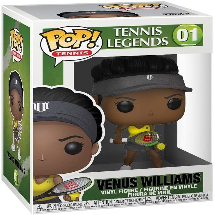 a figure of venus williams in a yellow tank top holding a racquet in the packaging