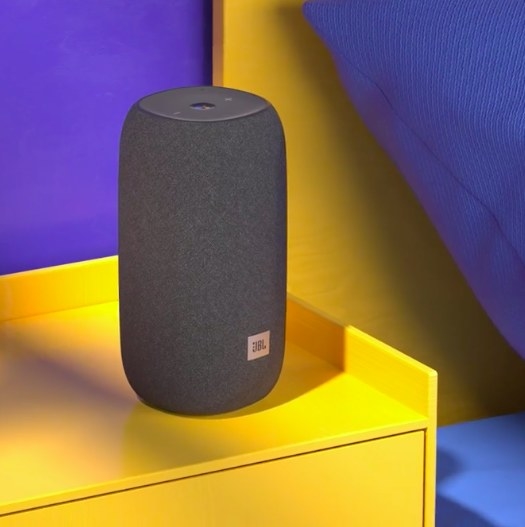 gray JBL speaker on the yellow side table