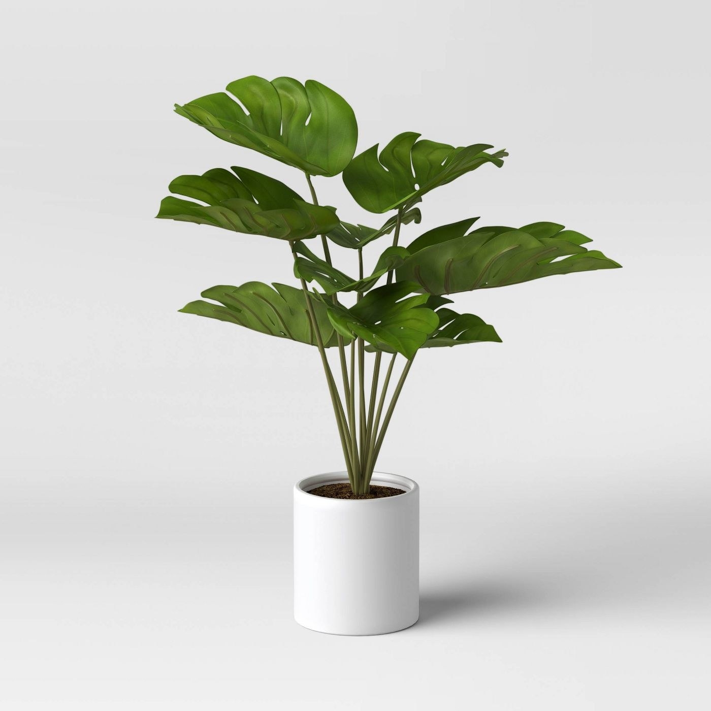 artificial monstera plant in a white pot