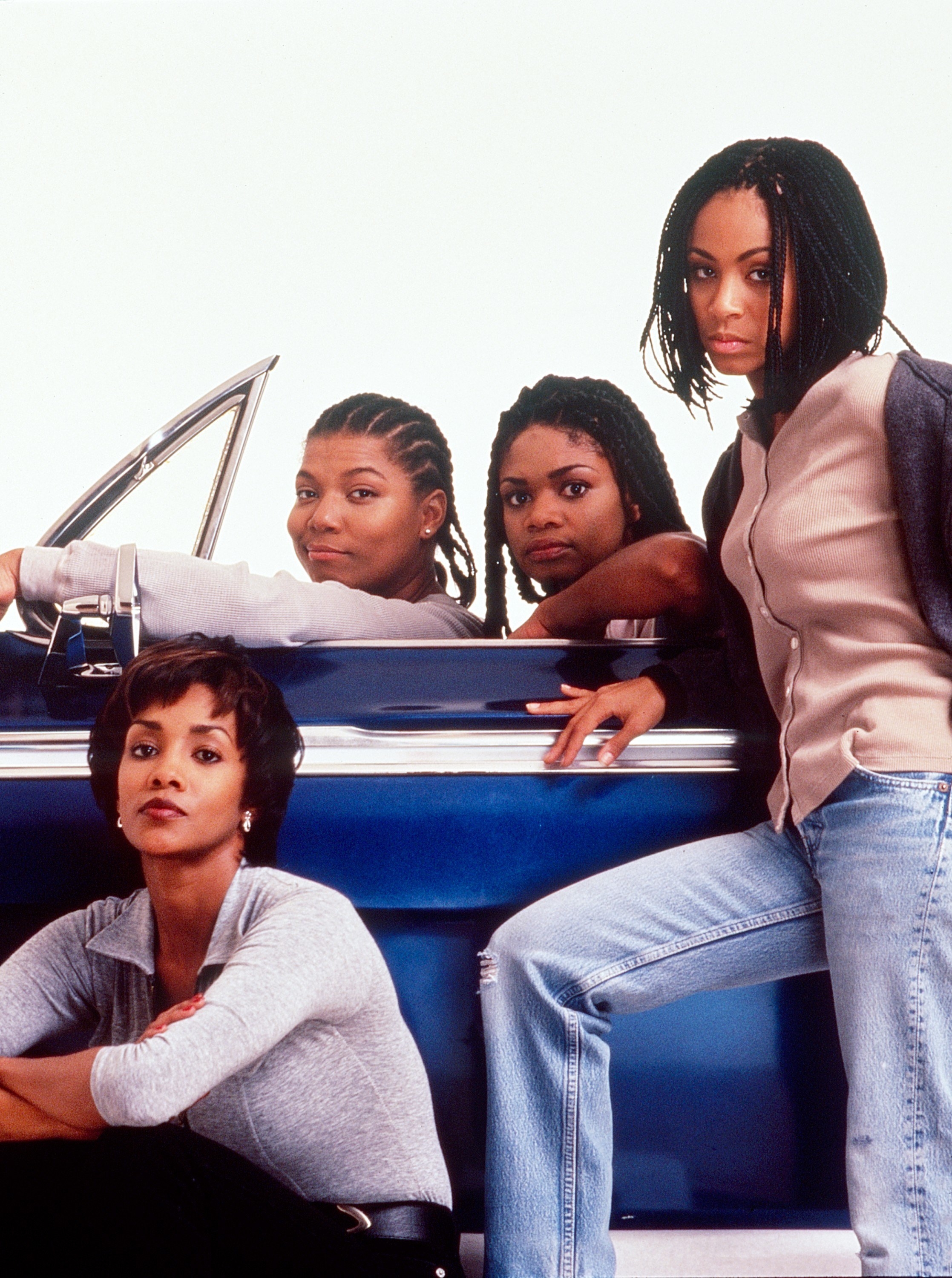 Vivica A. Fox, Queen Latifah, Kimberly Elise, and Jada Pinkett Smith posing in a car on the set of &quot;Set It Off&quot;