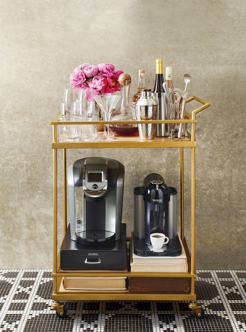 gold bar cart with drinkware on the top and coffee makers on the bottom